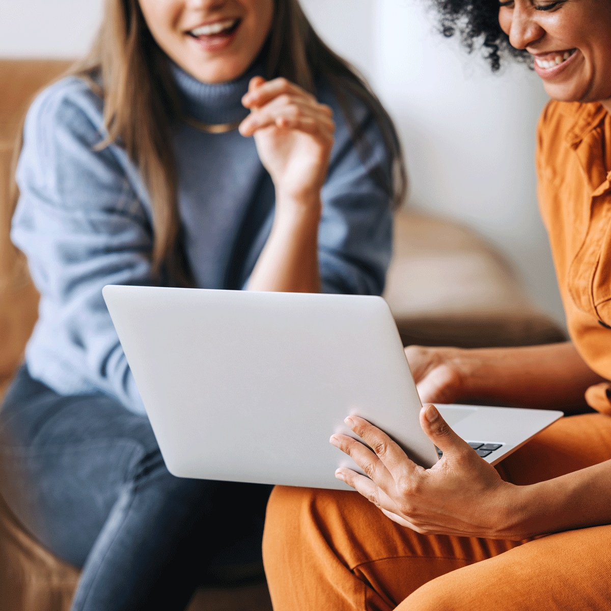 Two women looking at a laptop