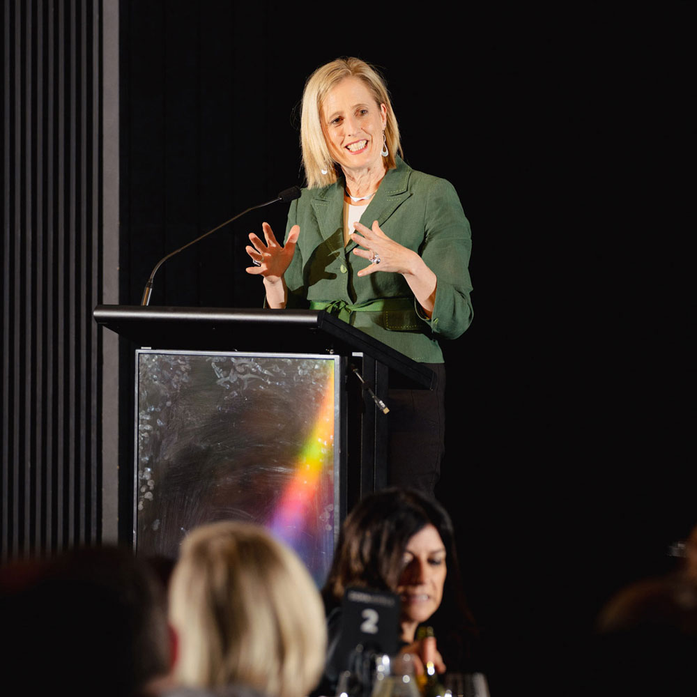 Minister for Women, Finance and the Public Service, Senator the Hon. Katy Gallagher is pictured standing at a lectern at the Future Women Federal Budget event.