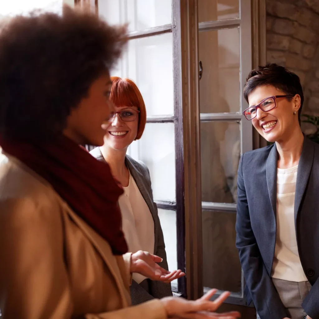 Three mid-career women networking.