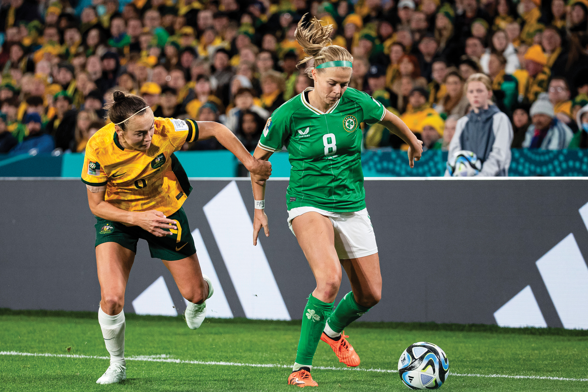 Ruesha Littlejohn and Caitlin Foord during a FIFA Women's World Cup 2023 Group B match. Littlejohn's ill-fitting shorts are see to be folded up on one side.